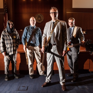 Band of Lawyers standing in courtroom with guitars in Oregon