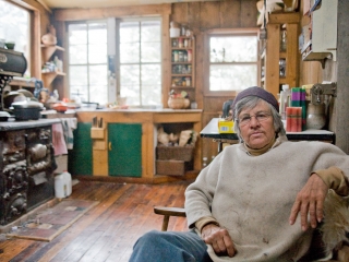 Montana Artist Nan Parsons sits in the rustic house she built herself outside of the small town of Basin