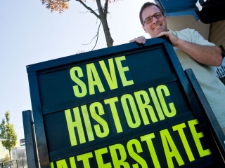 Bill Mildenberger Jr. Manager of the Nite Hawk Cafe with Save Historic Intersate AVE sign