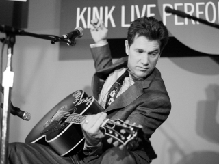 Chris Isaak plays guitar at the KINK Live Performance Lounge