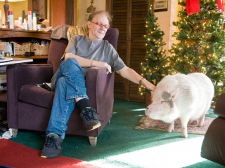 Martin Kasper and his pet pig Buddy Moon resting at home