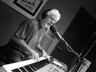 Michael McDonald sings in the sound studio at KINK fm 101.9.
