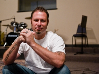 Paster Shaun of Red Sea Church sits in front stage in St. Johns